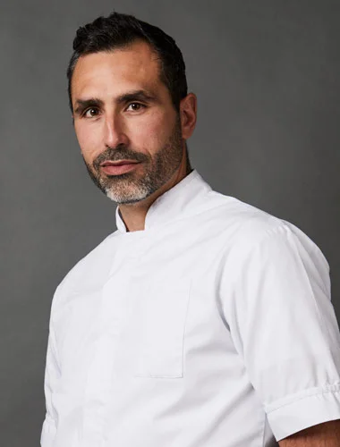 Portrait of Suhaib Molina Gonzalez in a white clinical tunic